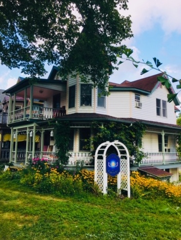 Aurora Guest House exterior sign and porch