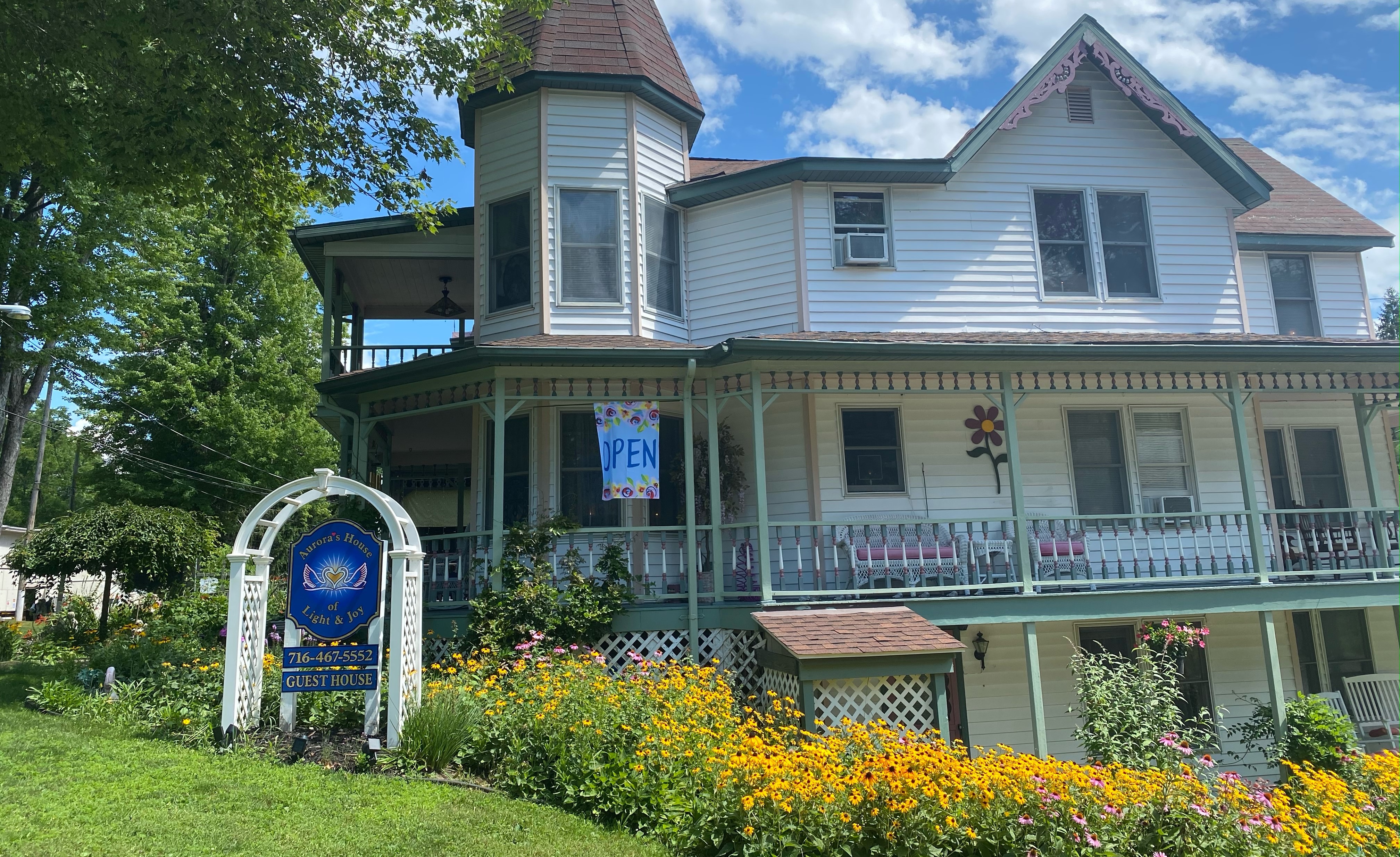 Aurora Guest House exterior with gardens in Lily Dale